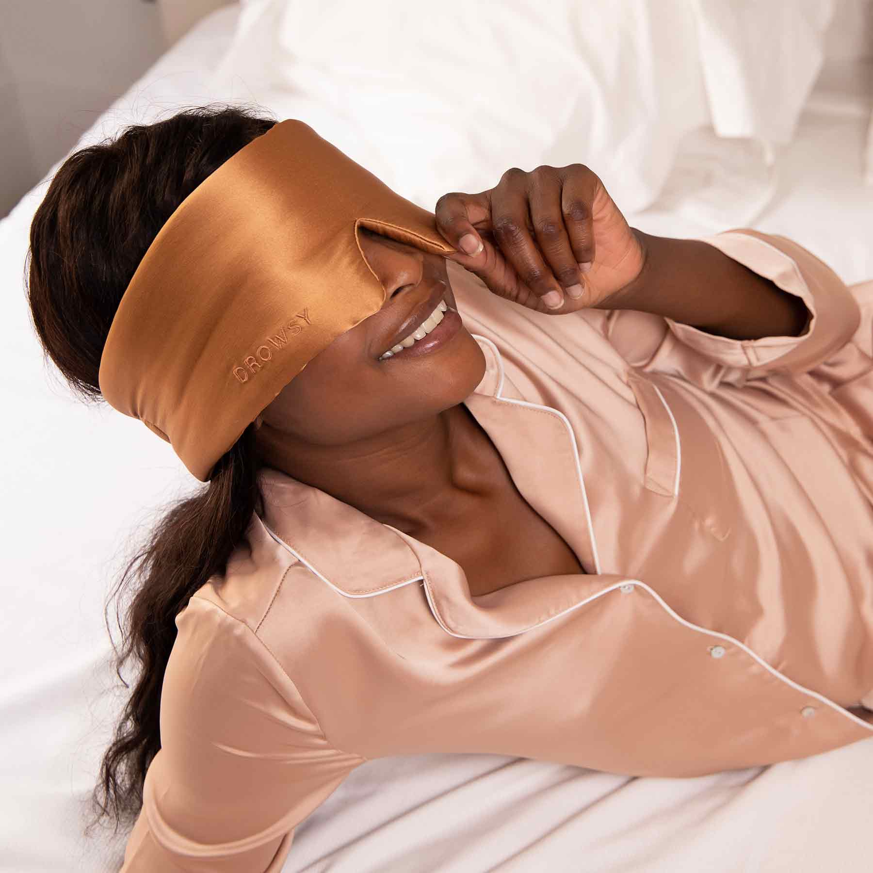 Drowsy-Sleep-Co.-Tuscan-Kiss-Light-Blocking-Silk-Sleep-Mask-With-Model-relaxing.jpg__PID:3bd65597-672a-437c-8d74-0ef65105f5f1